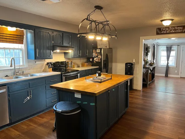 a kitchen with sink and cabinets