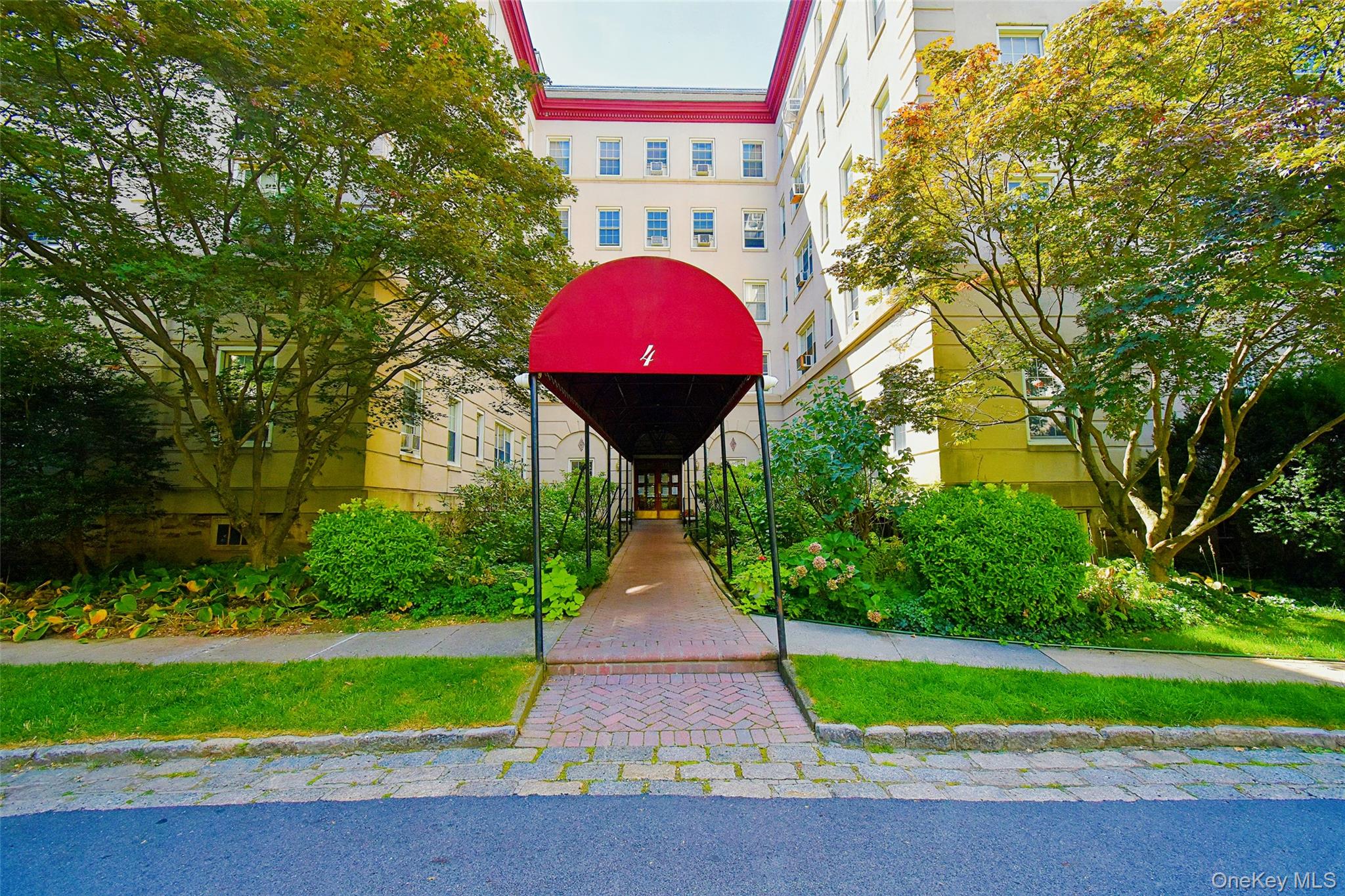 a view of swimming pool with a yard and plants