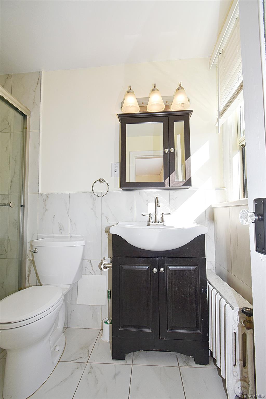 4 Park Lane, Unit 4B Mount Vernon, NY 10552 - Photo 11 of 19 a bathroom with a toilet sink and mirror