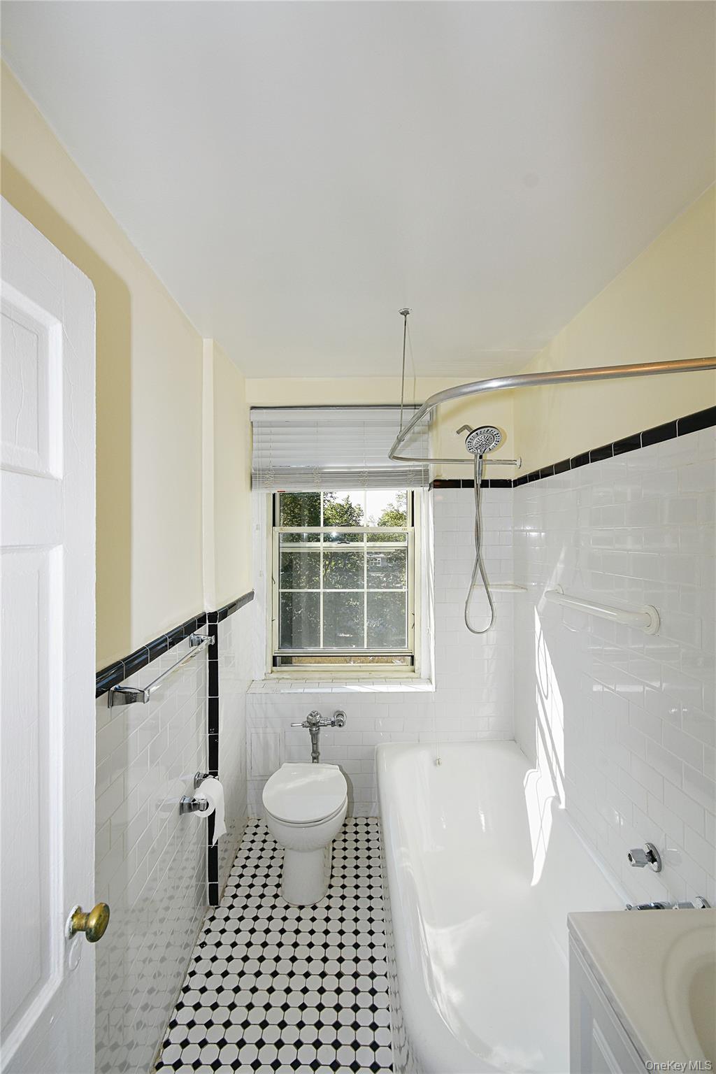 4 Park Lane, Unit 4B Mount Vernon, NY 10552 - Photo 13 of 19 a bathroom with a sink a toilet a window and shower