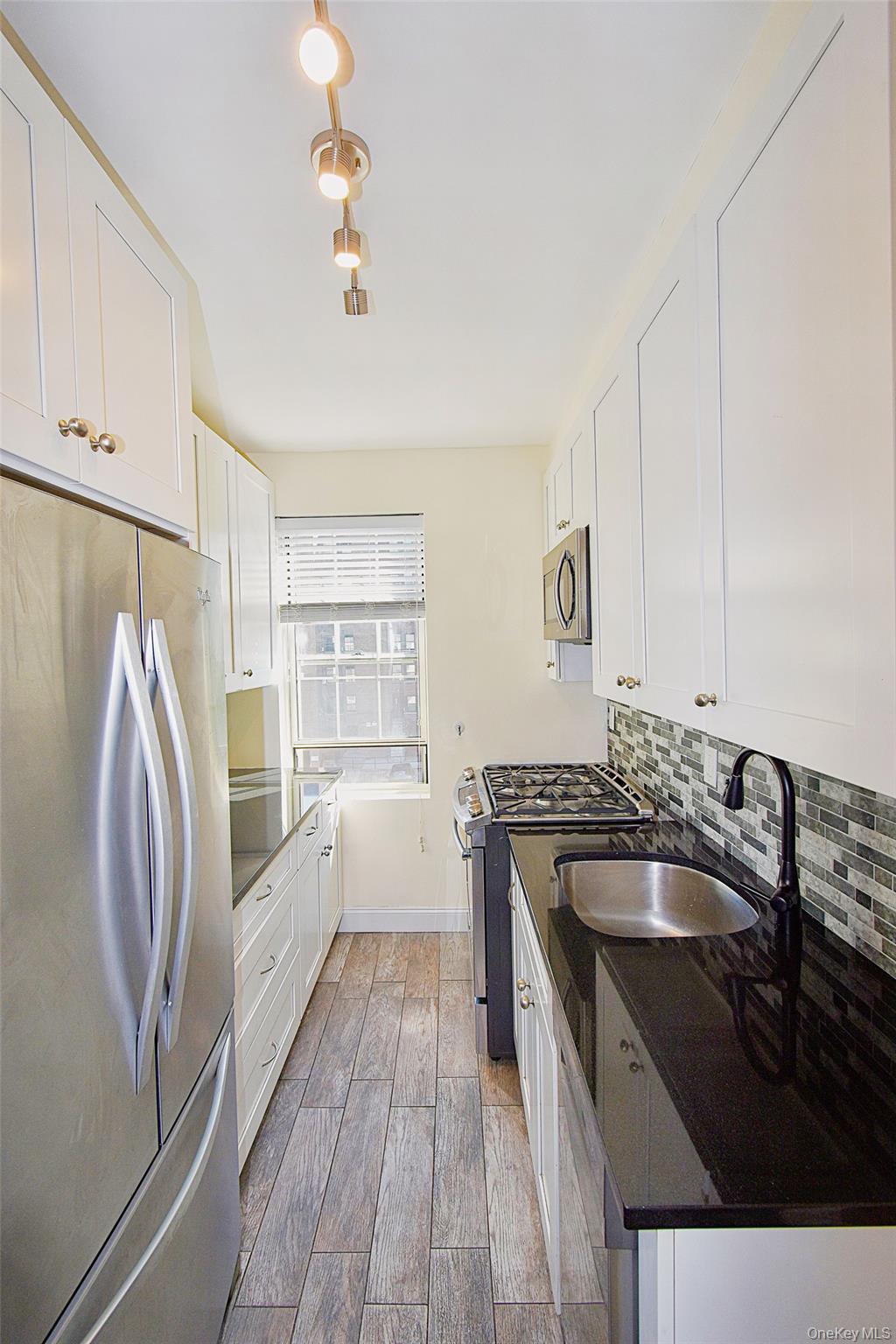 4 Park Lane, Unit 4B Mount Vernon, NY 10552 - Photo 5 of 19 a kitchen with a sink a stove and refrigerator