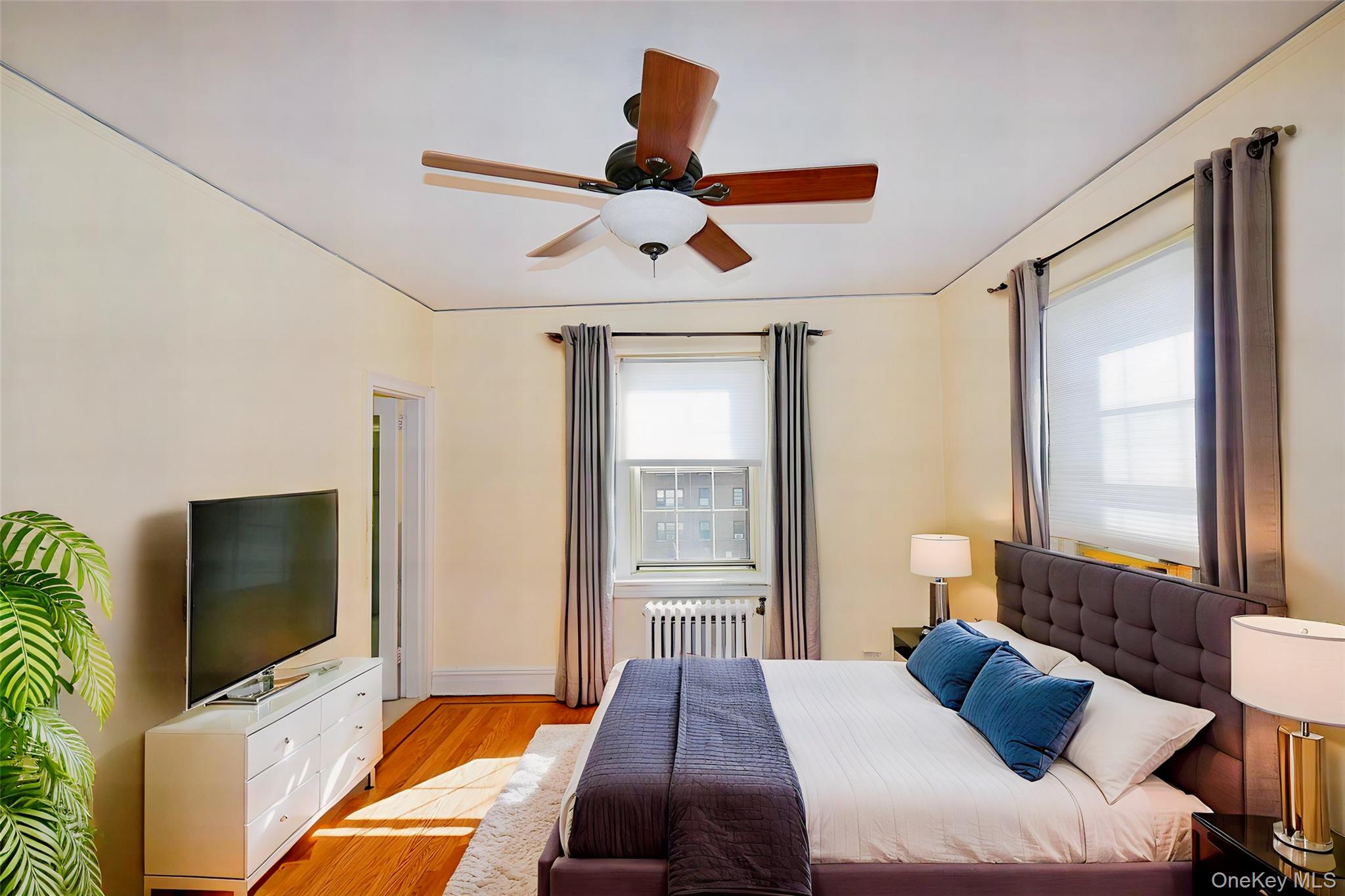 4 Park Lane, Unit 4B Mount Vernon, NY 10552 - Photo 9 of 19 a bedroom with a bed and a flat screen tv