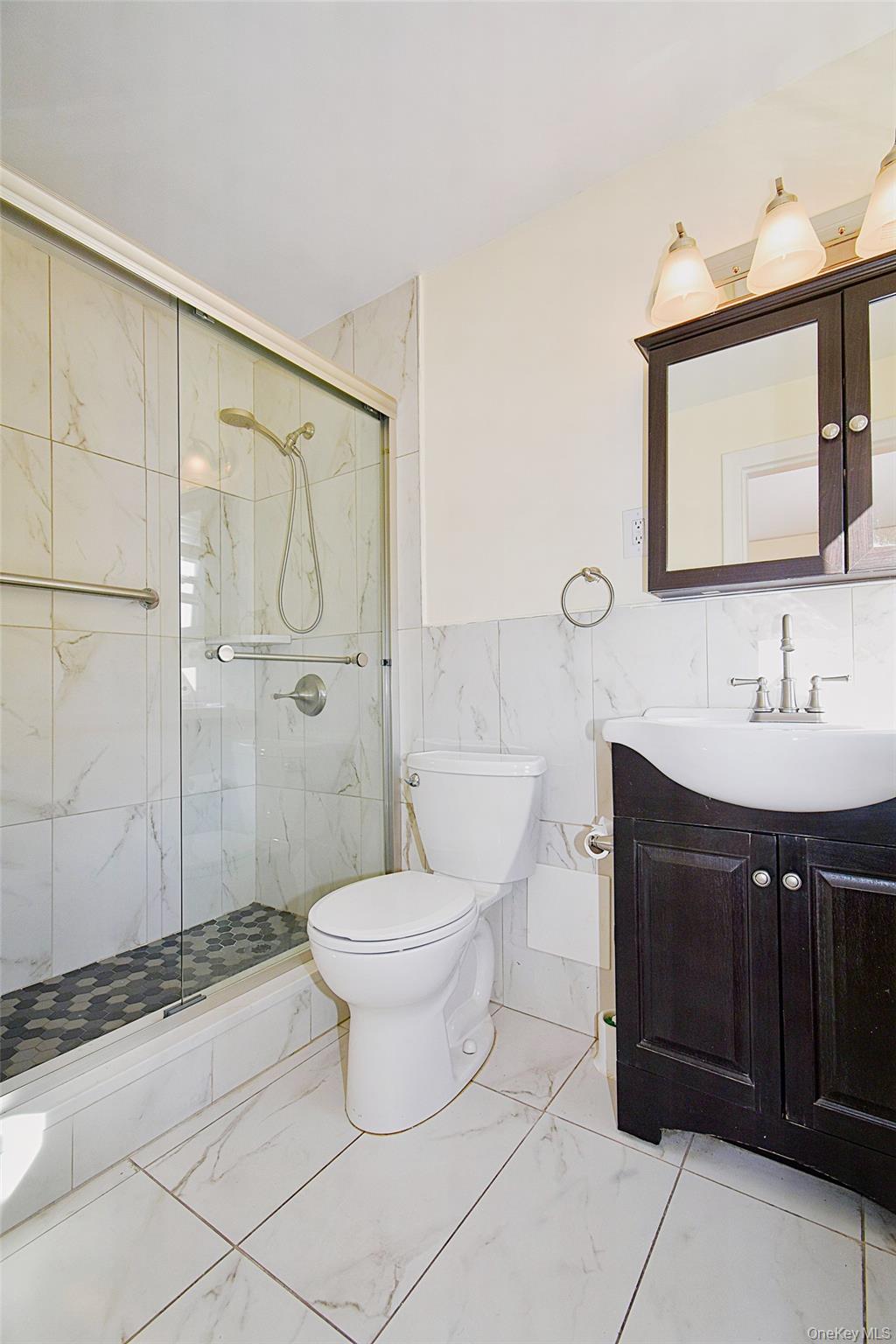 4 Park Lane, Unit 4B Mount Vernon, NY 10552 - Photo 10 of 19 a bathroom with a sink a toilet and shower