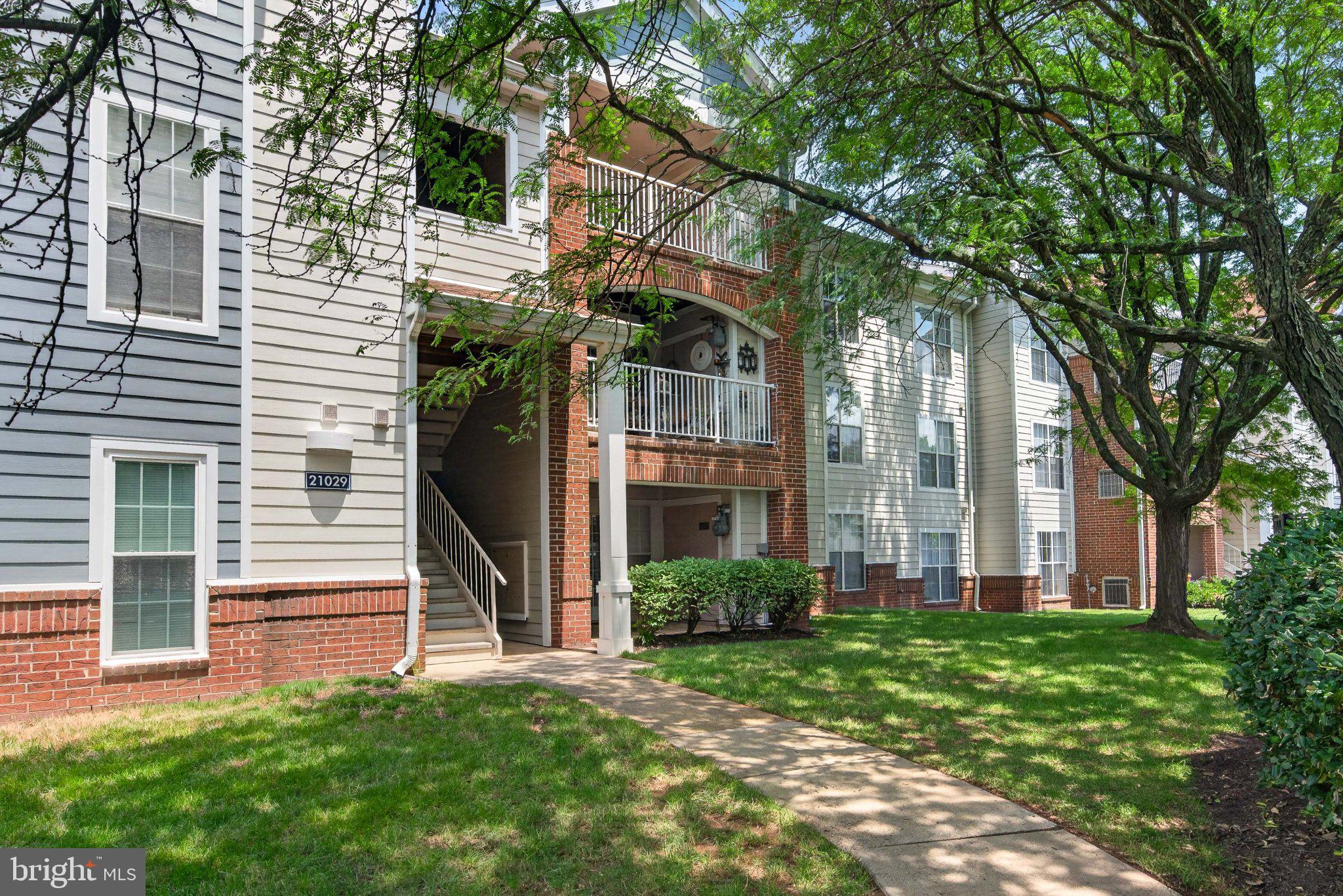 21029 Timber Ridge Terrace, Unit 302 Ashburn, VA 20147 - Photo 4 of 29 Charming apartment with lush greenery.