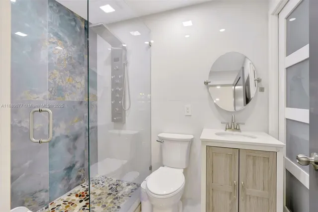 a bathroom with a sink toilet and shower