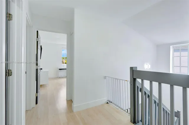 a view of a hallway with a livingroom and a bathroom