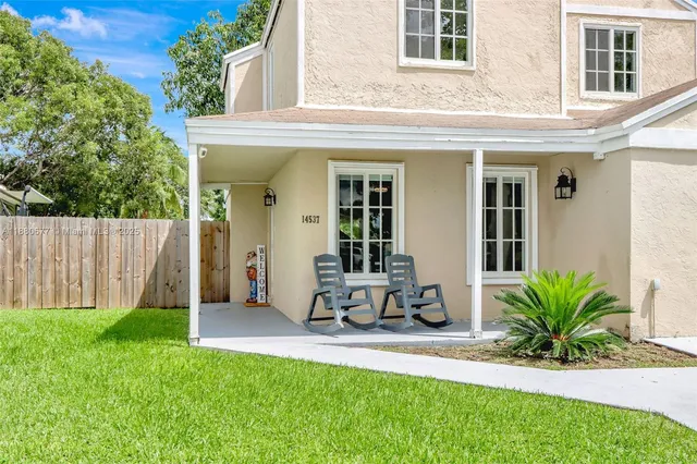 a view of a backyard with a sitting area and slide