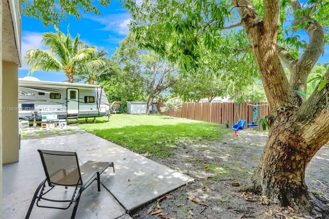 a front view of a house with a yard table and chairs