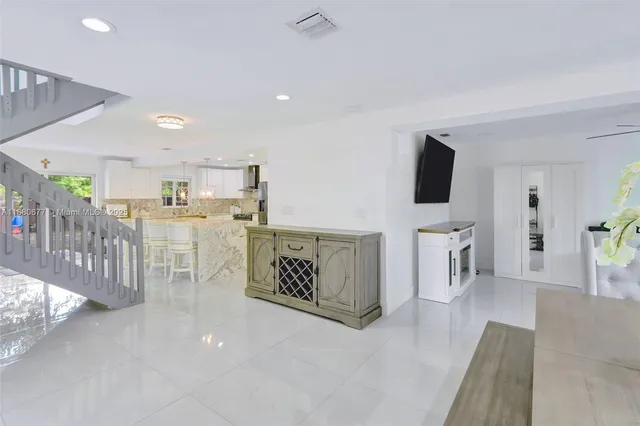 a view of a livingroom with furniture and a flat screen tv