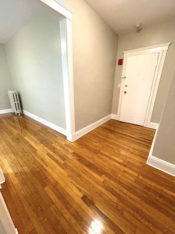660 Huntington Avenue, Unit 58 Boston, MA 02115 - Photo 2 of 19 a view of empty room with wooden floor