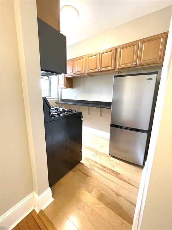 660 Huntington Avenue, Unit 58 Boston, MA 02115 - Photo 5 of 19 a kitchen with a refrigerator and a stove