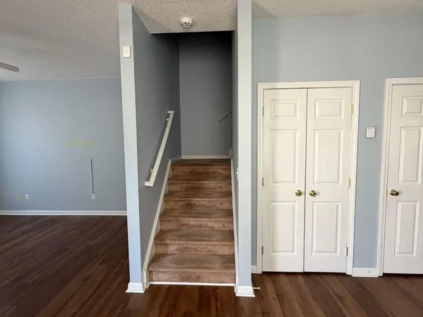 a view of a hallway with wooden floor and entryway