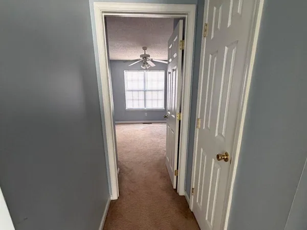 a view of a bathroom from a corridor