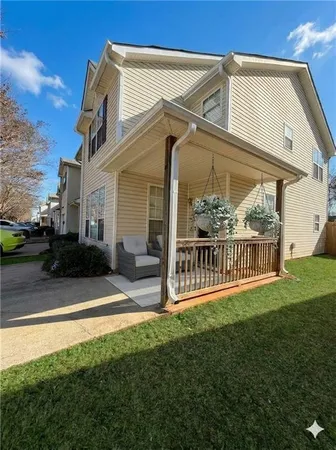 a view of a house with a yard and porch
