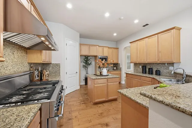 a kitchen with a stove a sink and a refrigerator