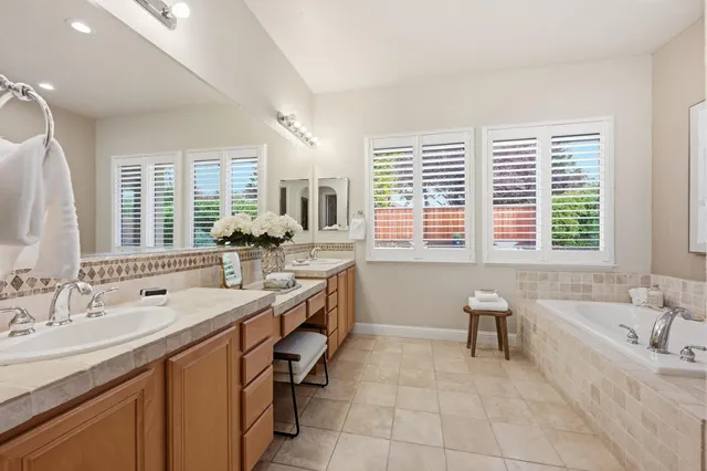a spacious bathroom with a sink double vanity and a bathtub