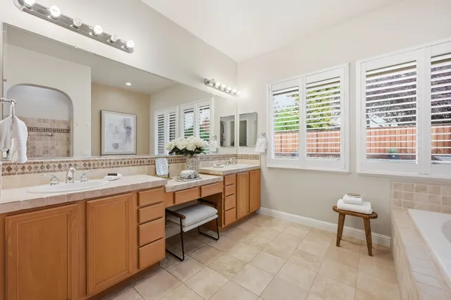 a bathroom with a sink mirror and a bathtub