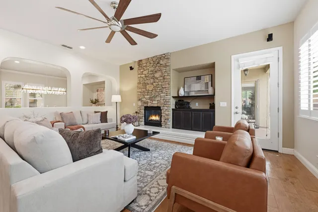 a living room with furniture kitchen view and a fireplace