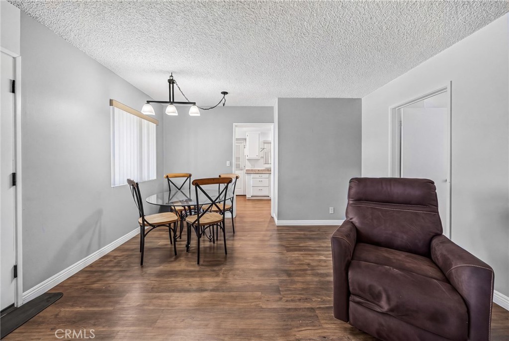 29078 Bradley Road Menifee, CA 92586 - Photo 13 of 42 a view of a dining room with furniture and wooden floor
