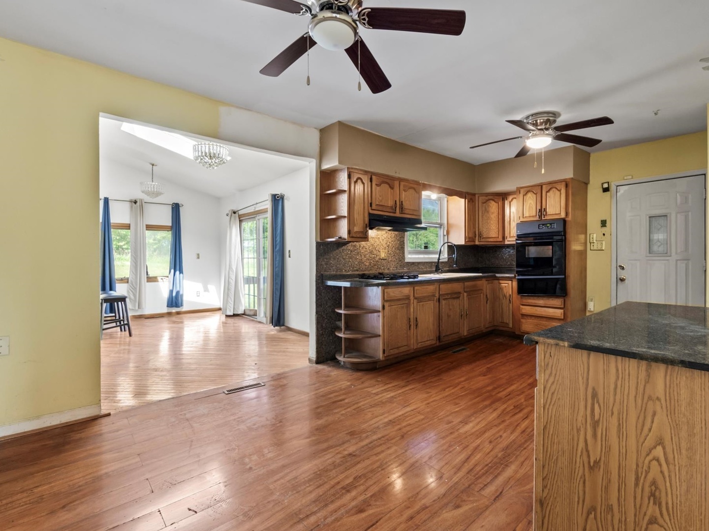 1317 Fairview Avenue Joliet, IL 60432 - Photo 3 of 19 a view of a kitchen with a sink cabinets and wooden floor