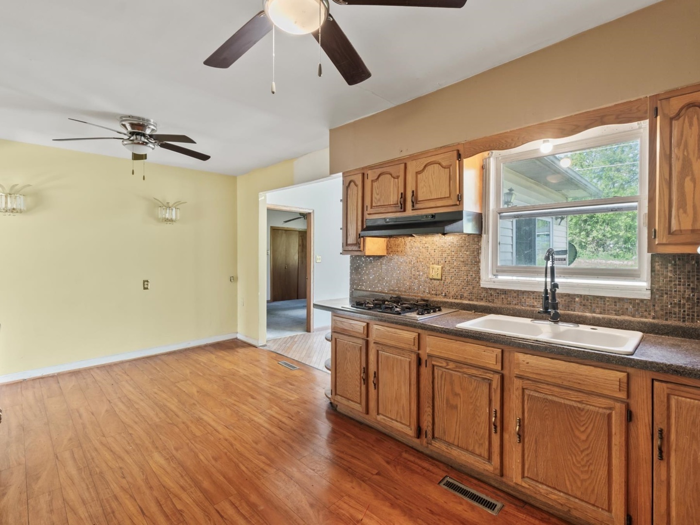 1317 Fairview Avenue Joliet, IL 60432 - Photo 4 of 19 a kitchen with stainless steel appliances granite countertop a sink a stove and a wooden floors
