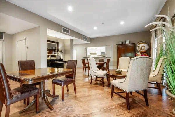 a living room with furniture wooden floor and a large window