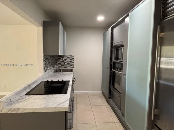 a kitchen with a refrigerator and a sink