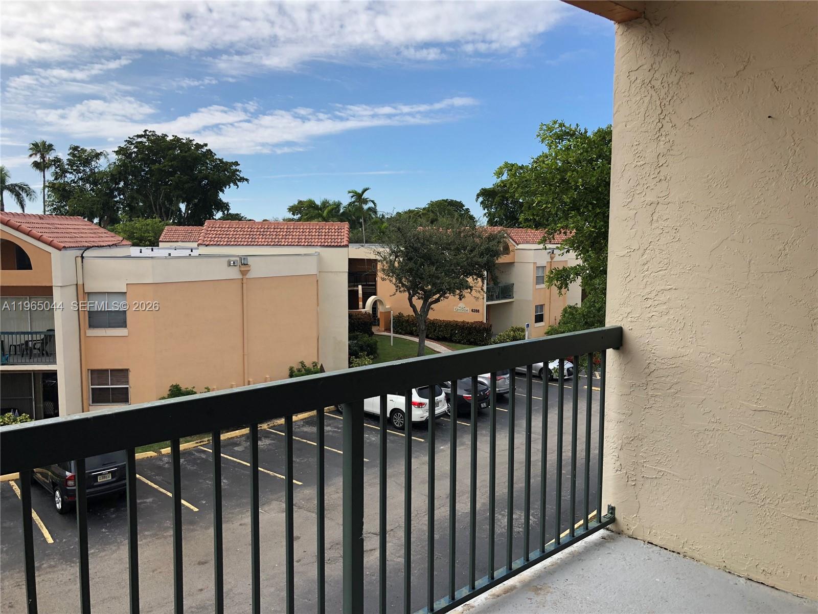 6280 Northwest 186th Street, Unit 311 Hialeah, FL 33015 - Photo 11 of 21 a view of a balcony with wooden fence
