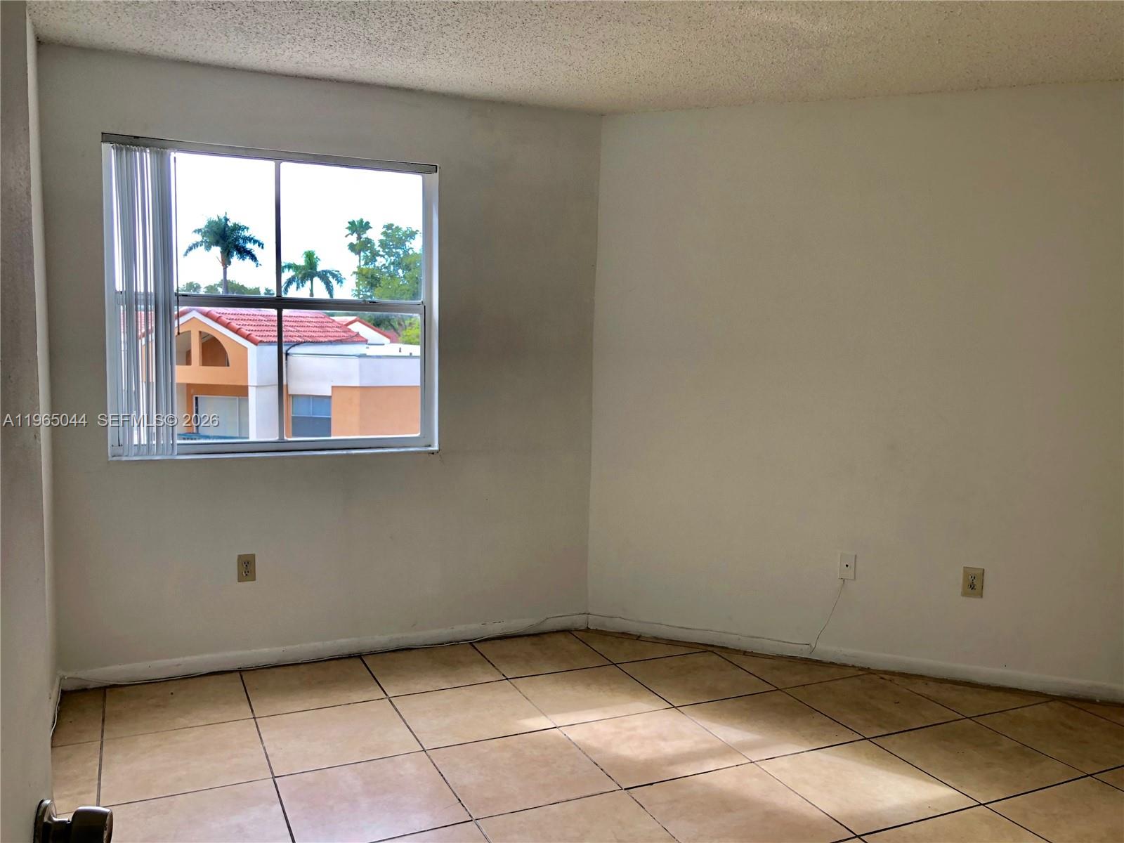 6280 Northwest 186th Street, Unit 311 Hialeah, FL 33015 - Photo 14 of 21 a view of an empty room and window