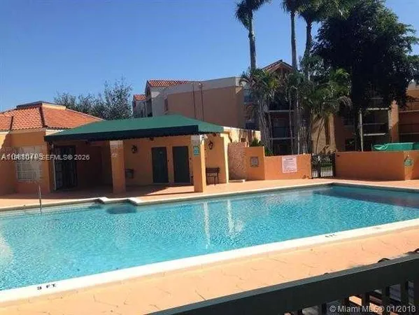 a view of a house with pool and a yard