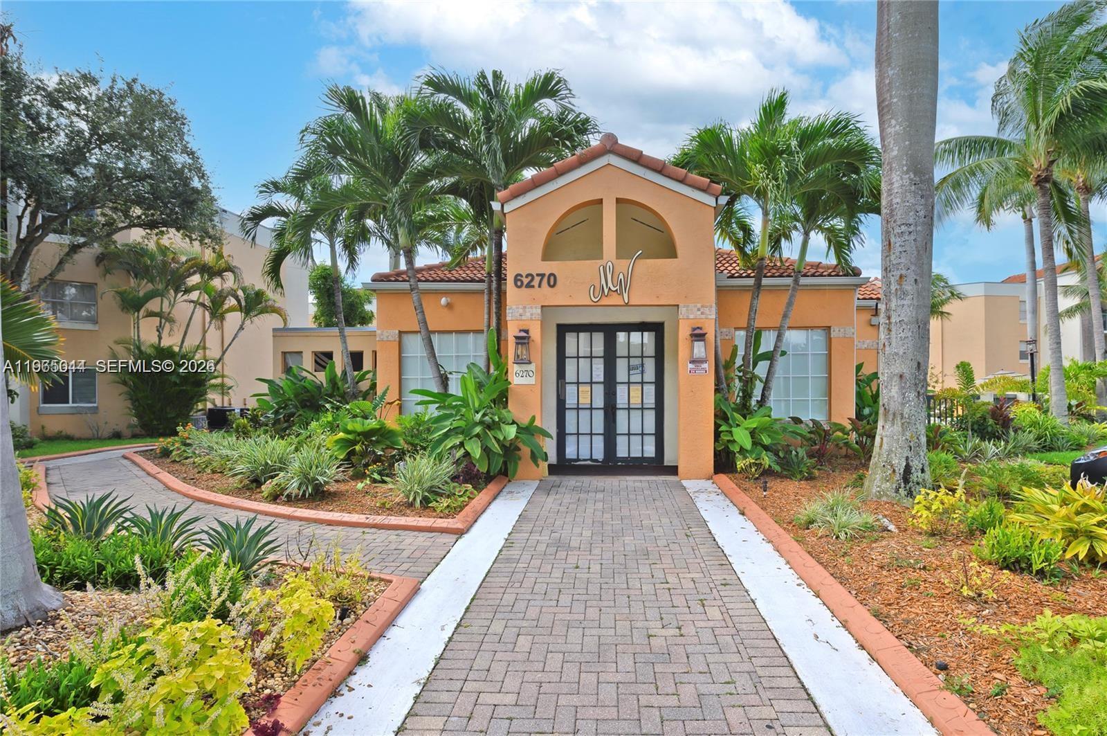 6280 Northwest 186th Street, Unit 311 Hialeah, FL 33015 - Photo 19 of 21 a front view of a house with a yard