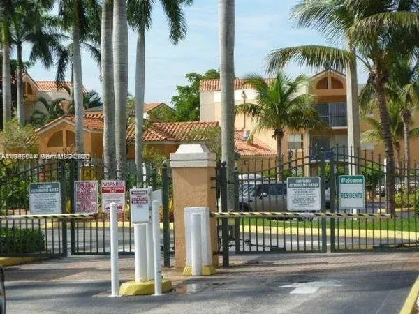a view of a house with swimming pool and wooden fence
