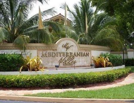 6280 Northwest 186th Street, Unit 311 Hialeah, FL 33015 - Photo 2 of 21 a view of garden with a bench under palm trees