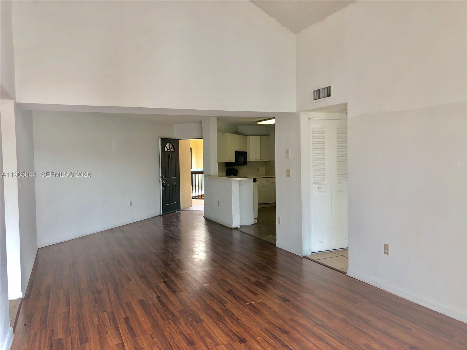 6280 Northwest 186th Street, Unit 311 Hialeah, FL 33015 - Photo 3 of 21 a view of a kitchen with wooden floor and a refrigerator