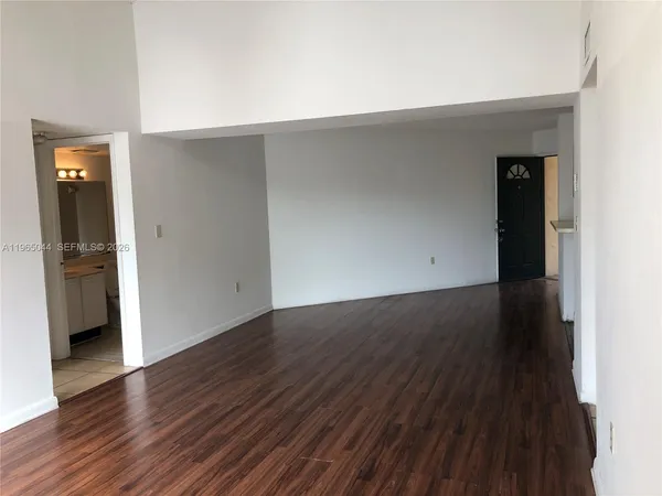 an empty room with wooden floor and closet