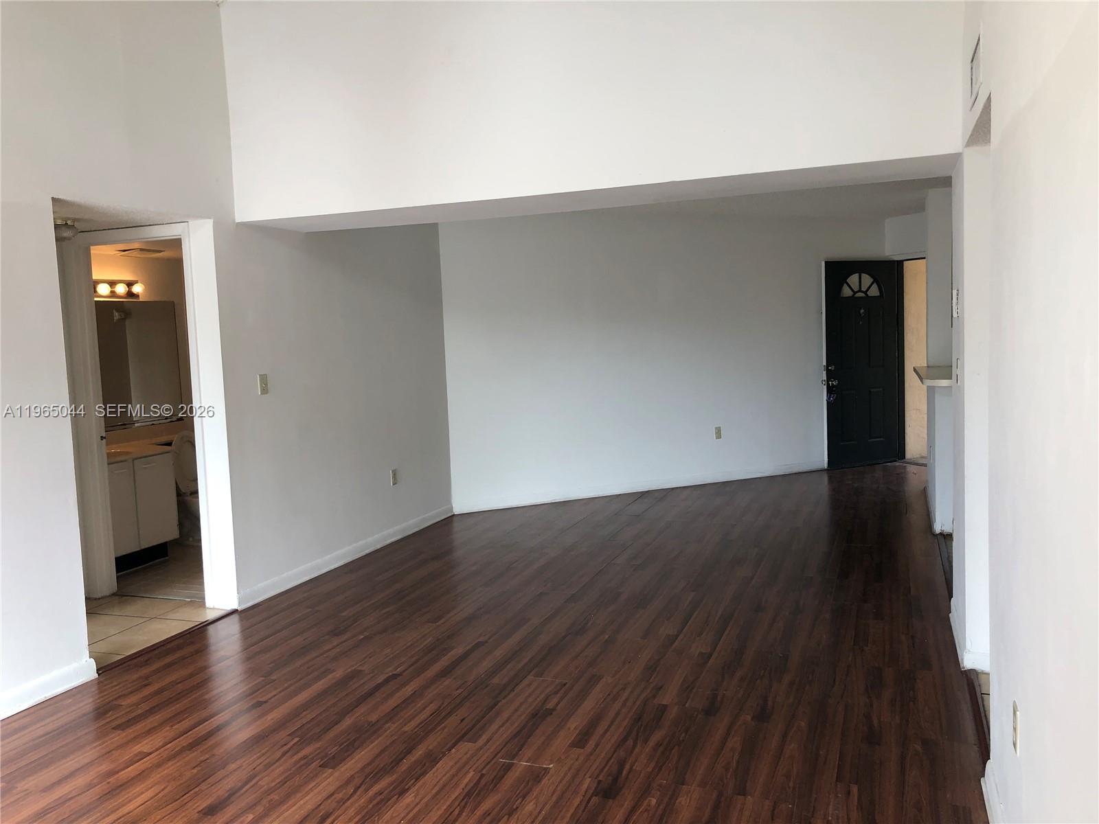 6280 Northwest 186th Street, Unit 311 Hialeah, FL 33015 - Photo 9 of 21 an empty room with wooden floor and closet