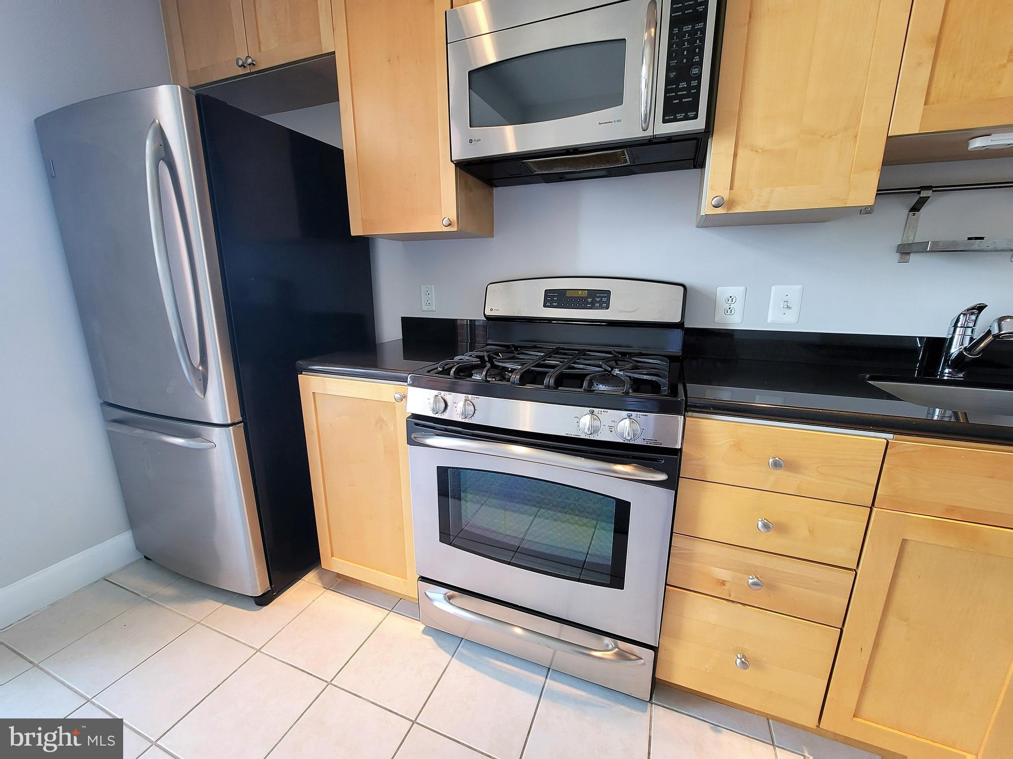 3600 South Glebe Road, Unit 602W Arlington, VA 22202 - Photo 29 of 46 a kitchen with stainless steel appliances granite countertop a stove a refrigerator and cabinets