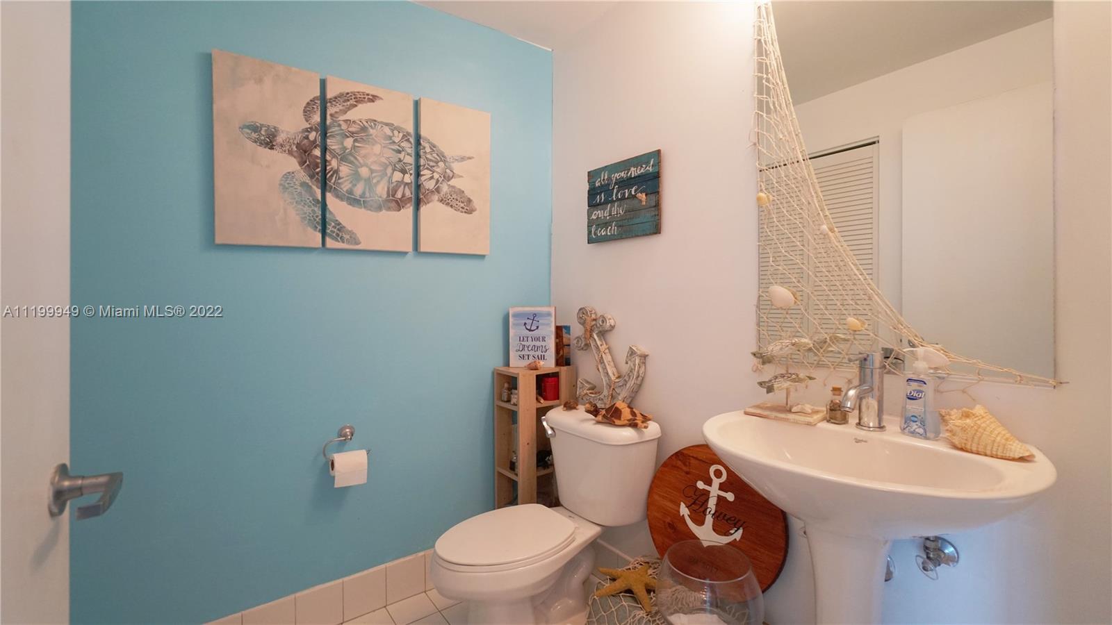 888 Biscayne Boulevard, Unit 811 Miami, FL 33132 - Photo 11 of 20 a bathroom with a toilet a sink and mirror