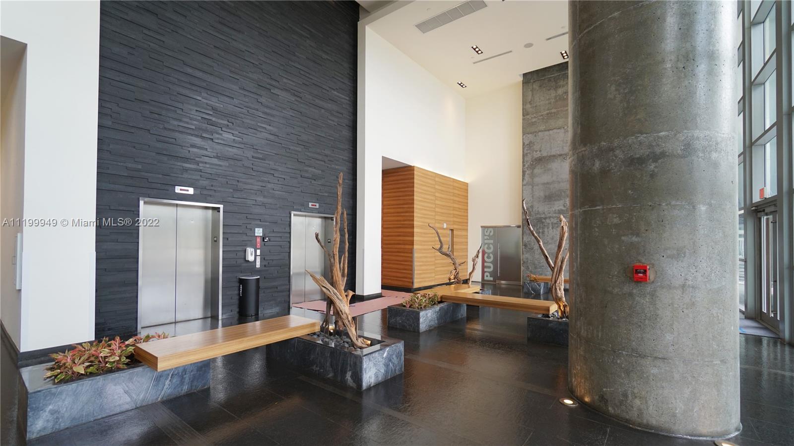 888 Biscayne Boulevard, Unit 811 Miami, FL 33132 - Photo 4 of 20 a view of room with gym equipment