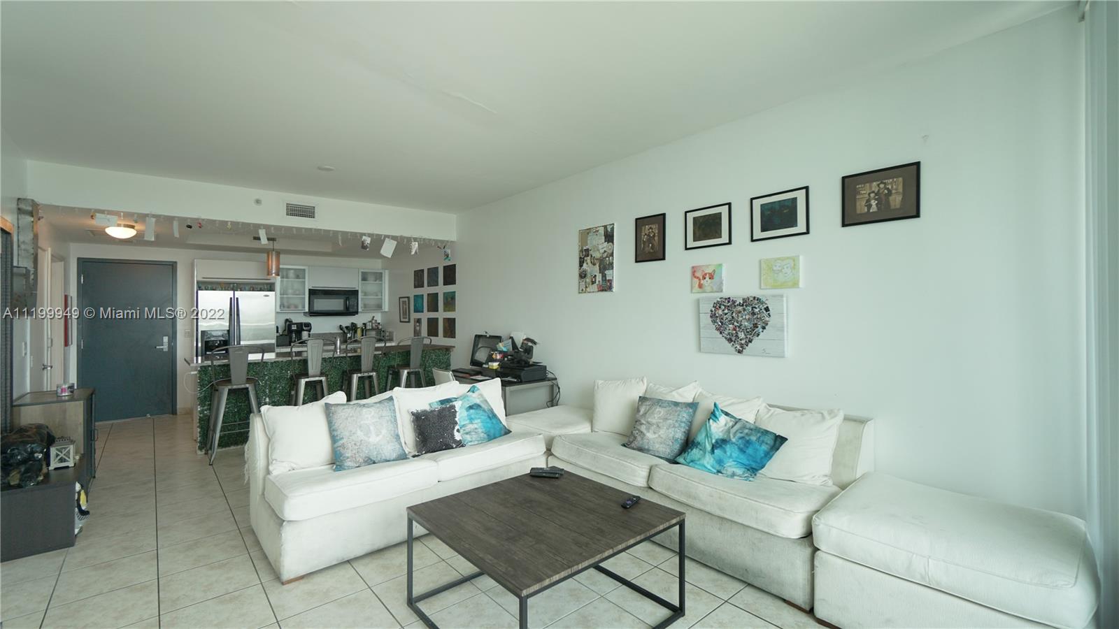 888 Biscayne Boulevard, Unit 811 Miami, FL 33132 - Photo 6 of 20 a living room with furniture and a table