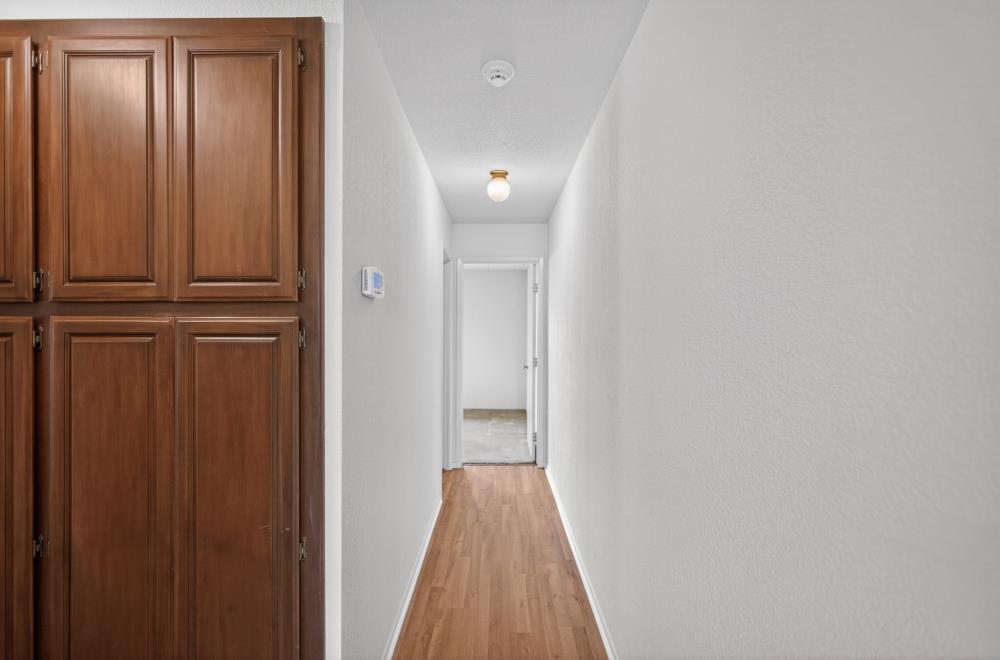 7649 El Modena Avenue Elverta, CA 95626 - Photo 29 of 75 a view of a hallway with wooden floor