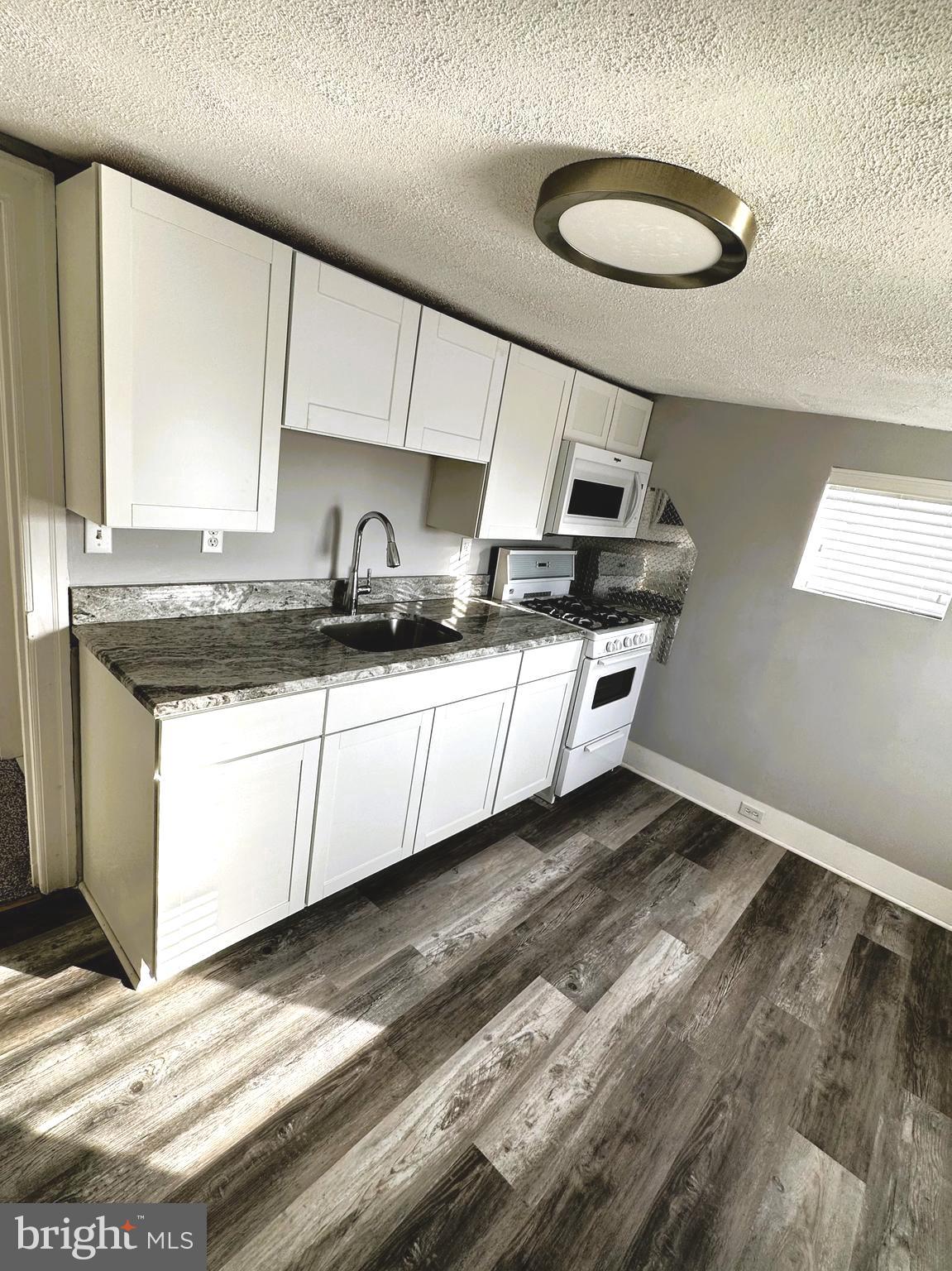163 Klockner Road Trenton, NJ 08619 - Photo 8 of 22 a kitchen with stainless steel appliances granite countertop a sink and a stove