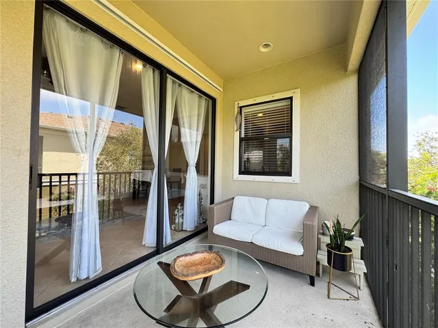 a living room with furniture and a floor to ceiling window