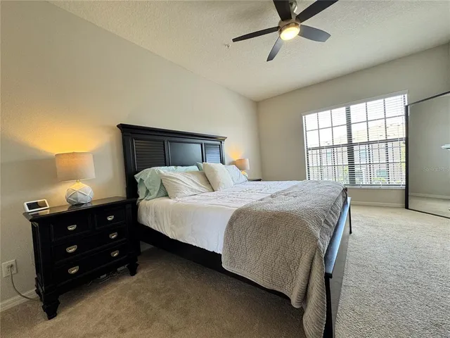 a bedroom with a bed and a night stand