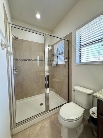 a bathroom with a shower and a toilet