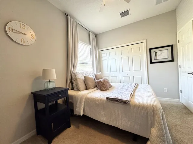 a bedroom with a bed and a lamp