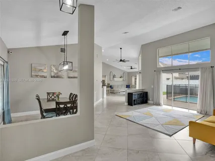 a kitchen with stainless steel appliances kitchen island granite countertop a refrigerator and a sink