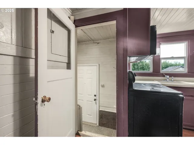 a view of hallway with wooden floor