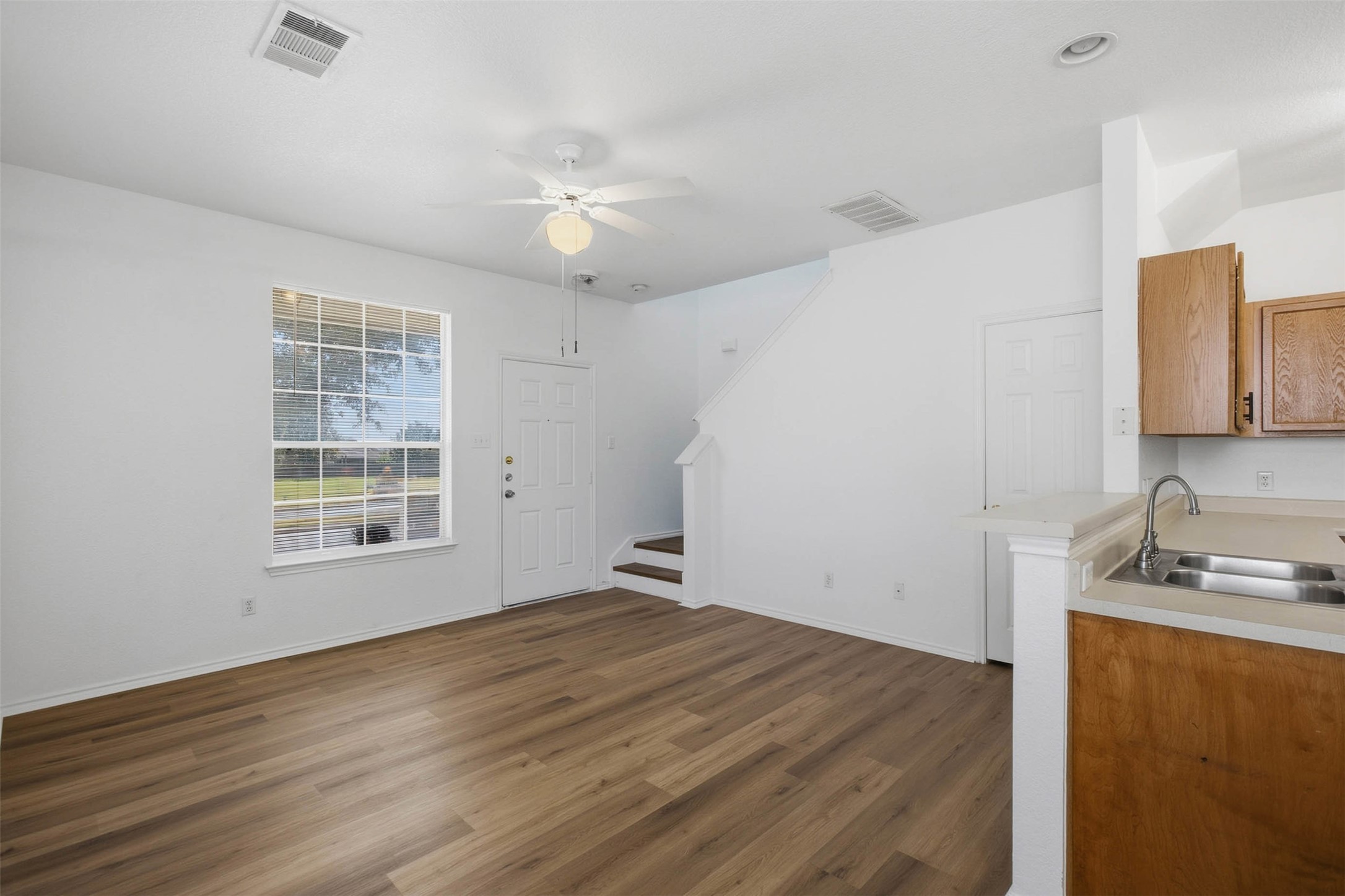 13808 Harris Ridge Boulevard, Unit B Pflugerville, TX 78660 - Photo 8 of 33 Hardwood floors and an open concept layout define this versatile main-level living space.