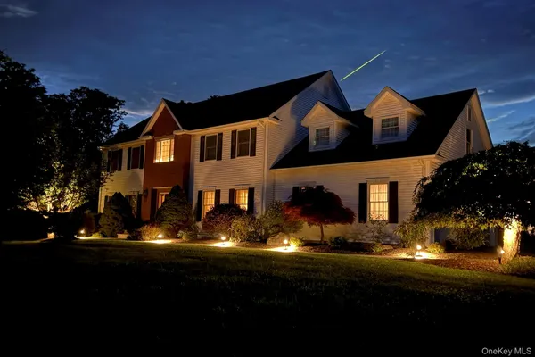 a front view of house with yard and green space